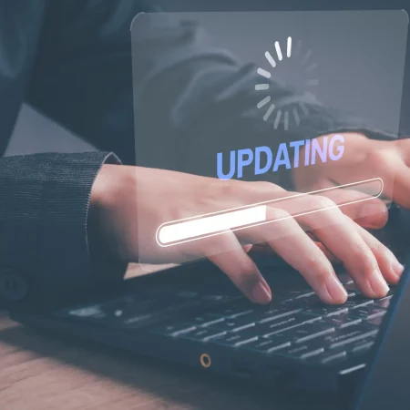 Installing software update process, operating system upgrade concept. Hand using laptop with Installing app patch or app new version updating progress bar on virtual screen. Installing software update process, operating system upgrade concept. Hand using laptop with Installing app patch or app new version updating progress bar on virtual screen.